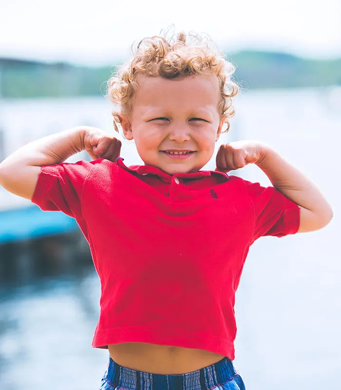 little boy holding up strong arms